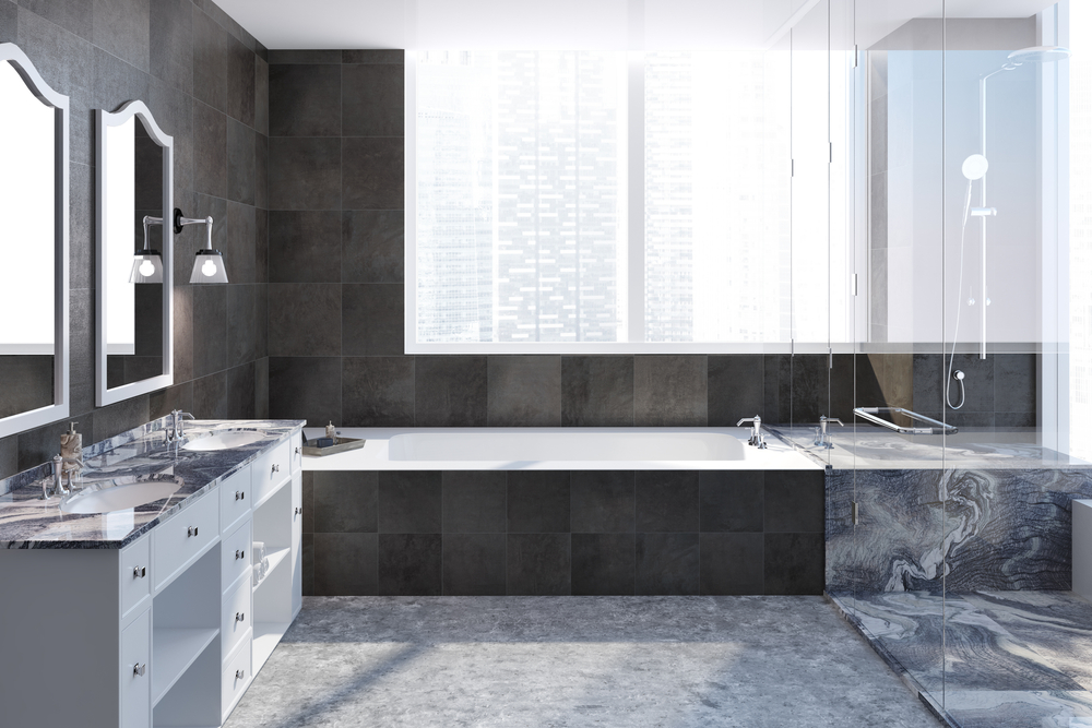 Dark tiled bathroom interior with a large bathtub, a shower and a black marble double sink with two square mirrors hanging above it. 3d rendering