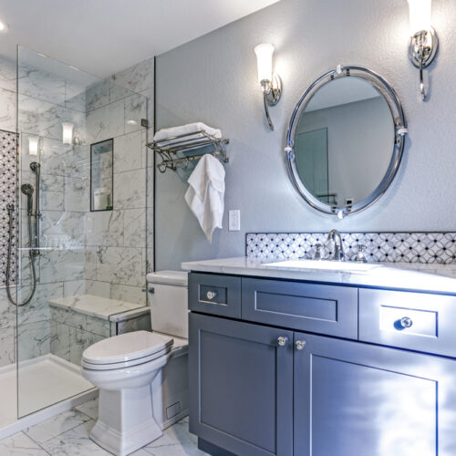 Luxury bathroom design with Marble shower Surround and mosaic accent tiles.