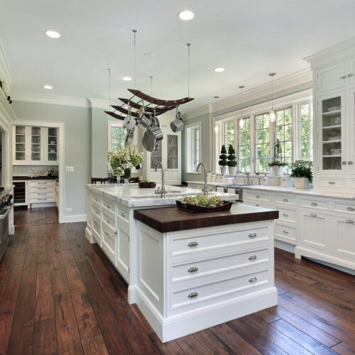 Kitchen in luxury home with white cabinetry